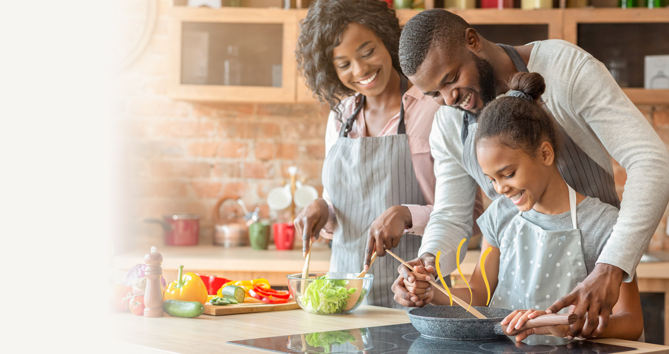 Family cooking together with their child